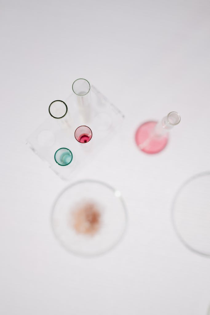 Overhead view of colorful lab glassware with copy space, perfect for science-themed designs.